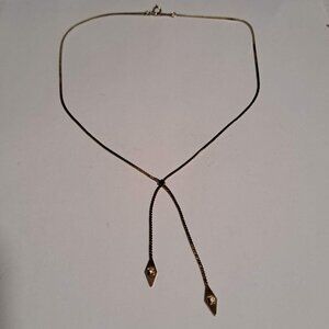 Avon gold tone necklace with 2 "tails" and diamond like stones double drops